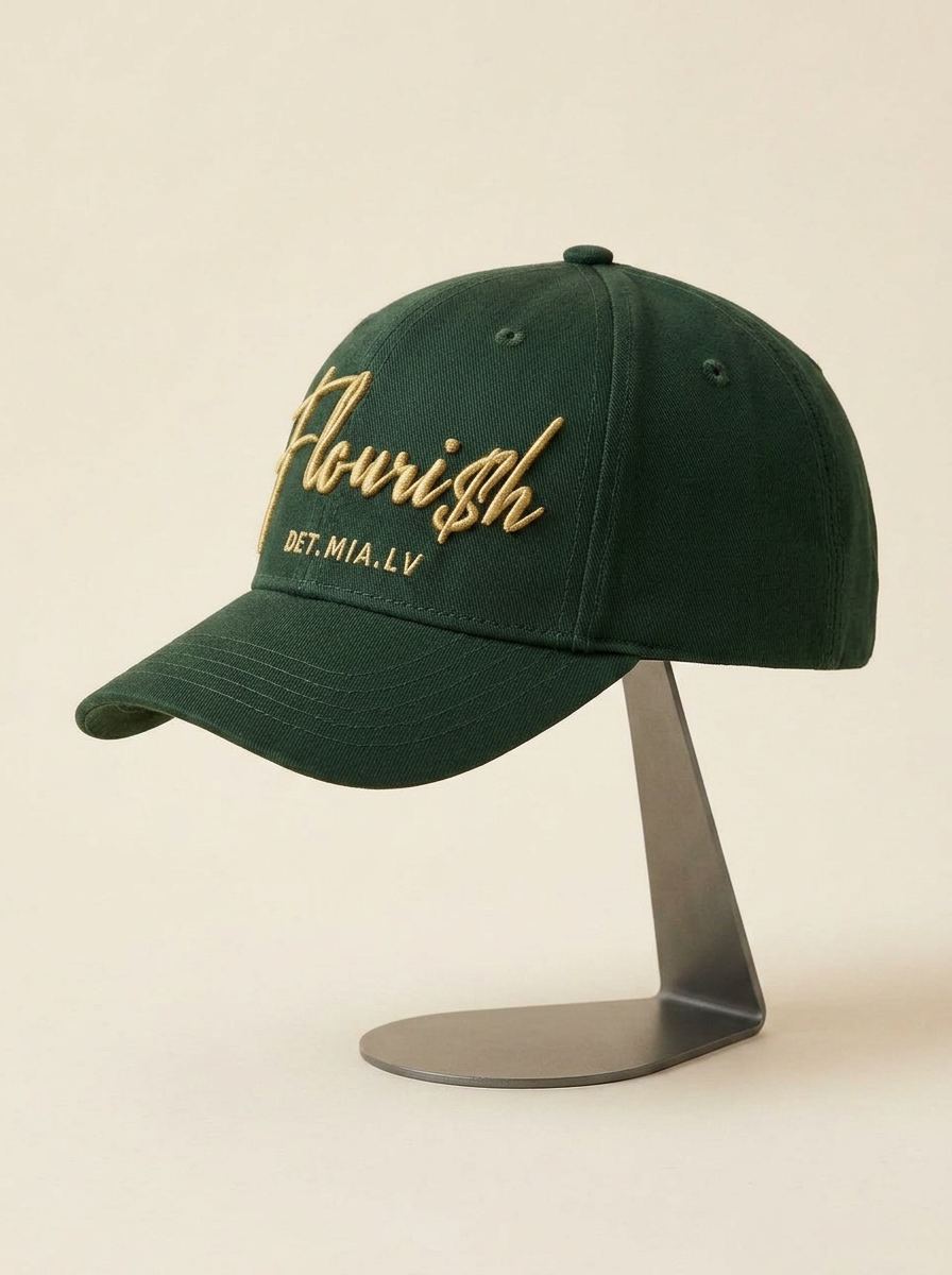 Three-quarter side view of the Flouri$h Cap on a stand showing the panel and brim